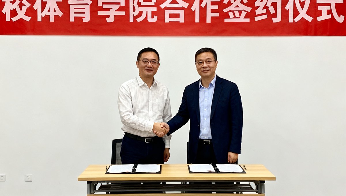 澳客数据研究院与某知名高校体育学院合作签约仪式的现场照片，双方代表握手，背景是签约横幅